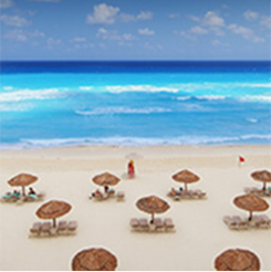 Beach chairs and umbrellas on a beach in Cancun, Mexico
