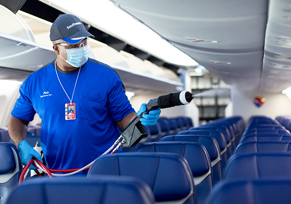 Southwest employee disinfecting airplane cabin