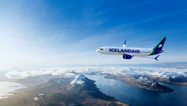 Icelandair aircraft flying over mountainous terrain